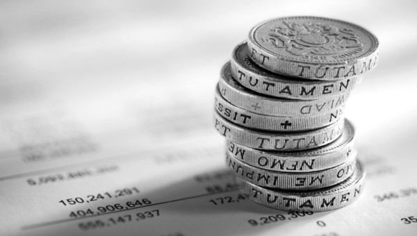 stack of pound coins on financial figures picture id532396653